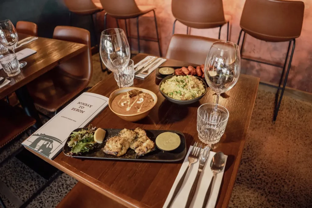 Curries, rice and tandoori dishes on a table at Bombay to Byron